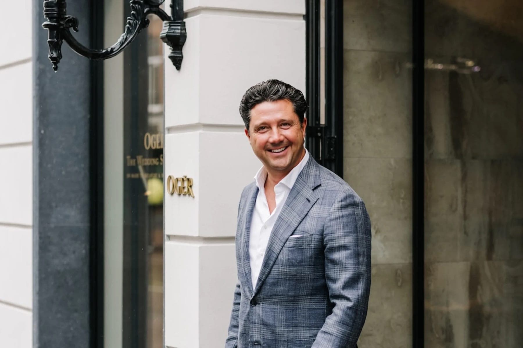 Sander Lusink in a blue check jacket outside the OGER store