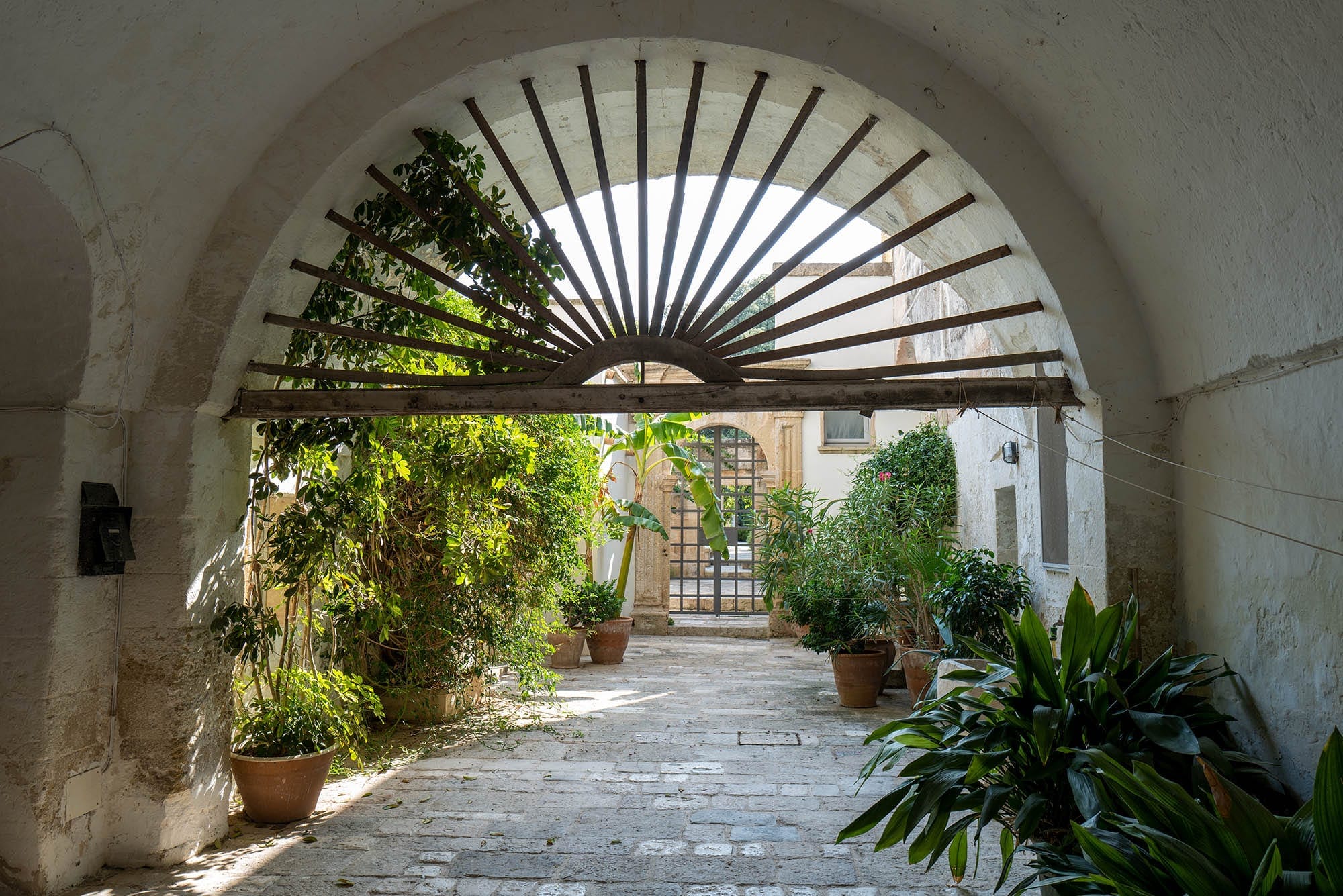 A stone arch opening onto the courtyard garden